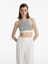 A lady wears a striped tank top.